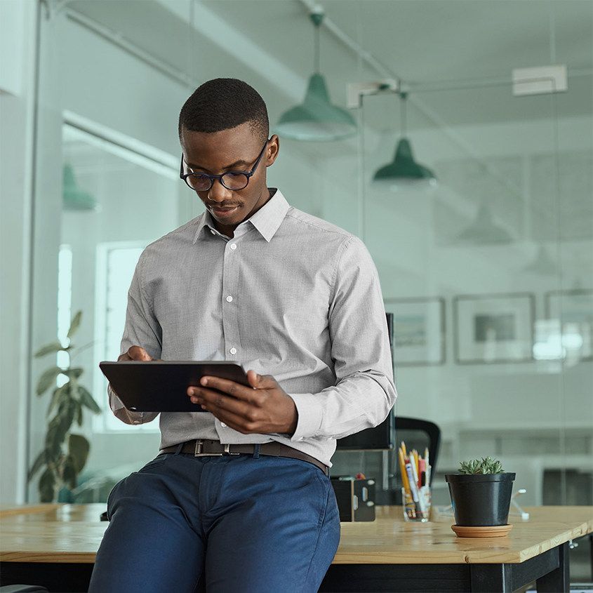Financial advisor in office on tablet