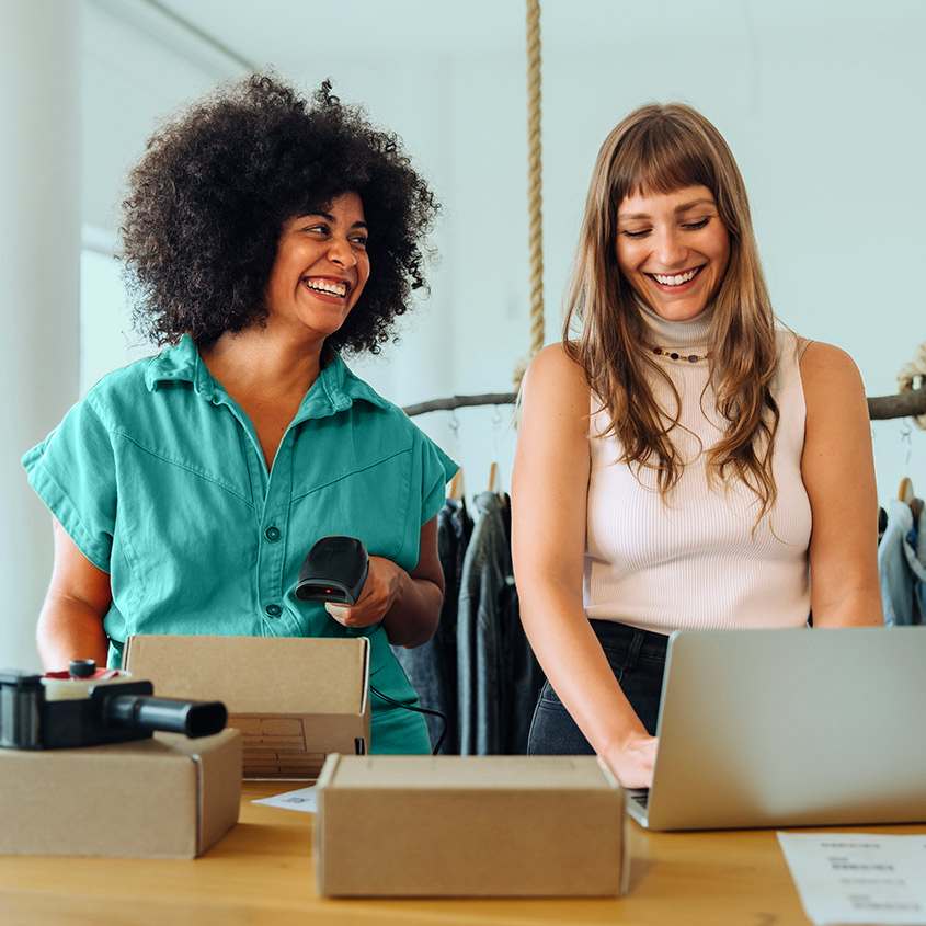 Two small business owners working on packages to be shipped