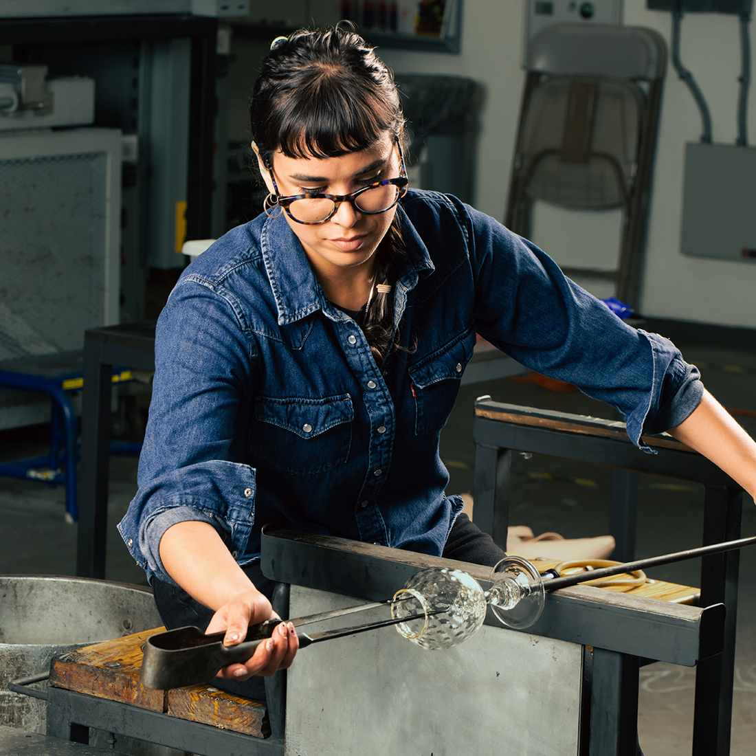 Glassblower working on a glass cup